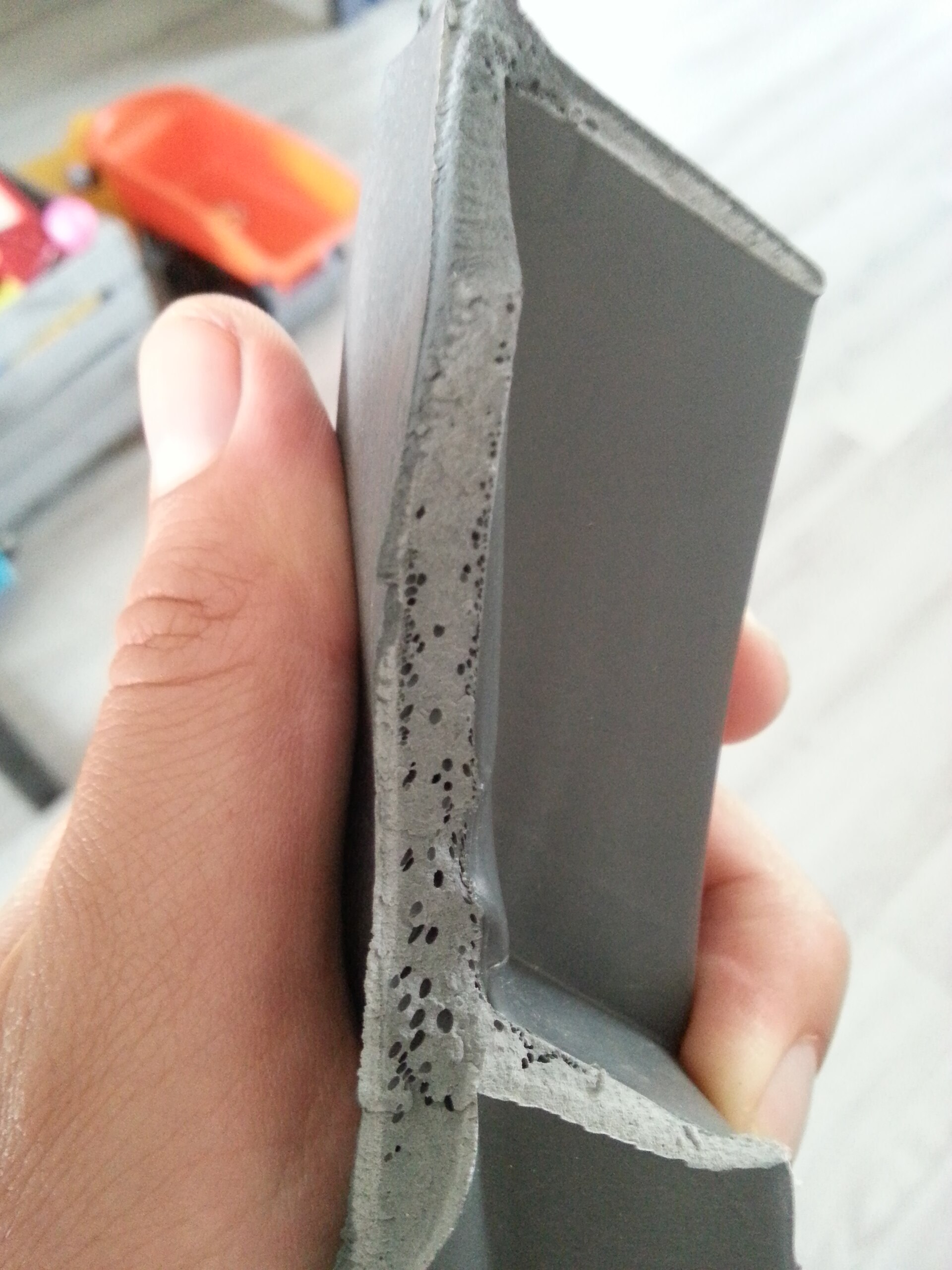 Real plastic part porosity defect photo from Wikimedia Commons for defect troubleshooting
